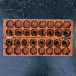 Handcrafted Rwandan Igisoro board made from Red Cedar wood – traditional African strategy game for home décor and cultural gifting.
