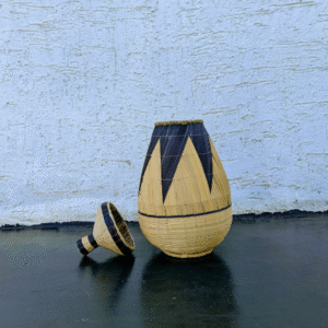 A handwoven Agaseke basket, known as the Basket of Unity, featuring a black and white pattern symbolizing peace and reconciliation.